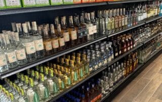 Liquor store shelf filled with various tequila bottles.