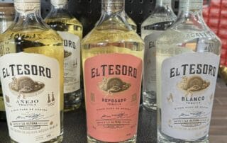 El Tesoro Tequila bottles on display shelf.